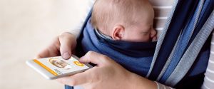 Baby with mother holding phone