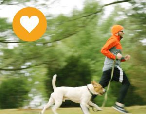 Young man running with a dog + heart icon